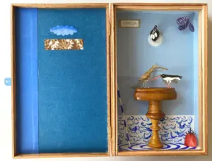 Tamar Rubinstein, twee vogels met ondergaande zon, 225 euro, Mixed media in cigar box, 27x35x4 cm